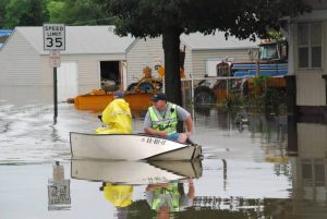 Iola police office Kelly Klubeck rides in a motorboat along South State Street on July 1, 2007 during a flood in Iola.